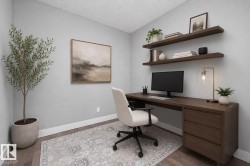 Dedicated workspace featuring wood-finish flooring, two floating wall shelves, a built-in desk with integrated drawers, and ample natural light - 