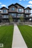 Modern tri-level townhome featuring a multi-tone facade with dark siding and beige accents - 22845 84 Avenue, Edmonton, AB 