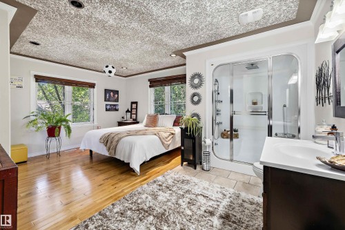 Integrated full bathroom featuring a glass-enclosed shower with multiple showerheads - 11124 110A Avenue Nw, Edmonton, AB 