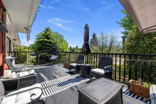 Spacious upper-level deck featuring a black metal railing and overhead soffit - 11124 110A Avenue Nw, Edmonton, AB 