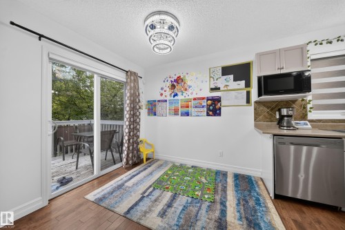 Sliding glass door opening to a private wooden deck - 4 4350 23 Street, Edmonton, AB 