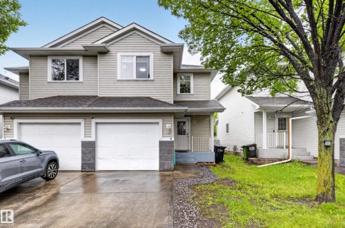 Split-level residence featuring light-colored siding and a two-car garage - 4 4350 23 Street, Edmonton, AB 