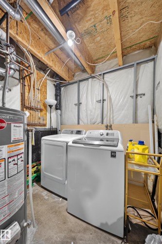 Dedicated laundry area with concrete flooring and exposed ceiling joists - 4 4350 23 Street, Edmonton, AB 