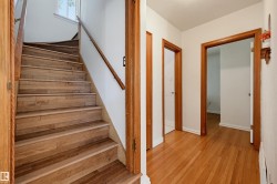 Hardwood staircase featuring a wood railing and white risers - 