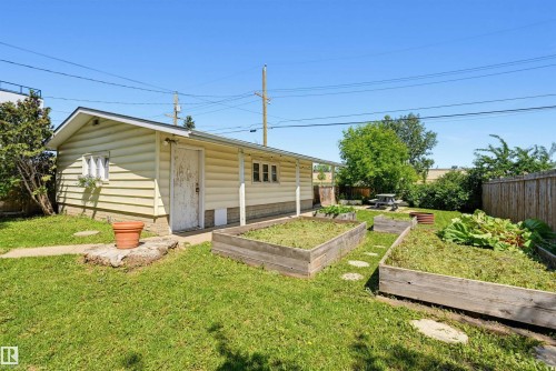 Detached auxiliary building with horizontal siding, multiple windows, and a side entry door - 11619 122 Street, Edmonton, AB 