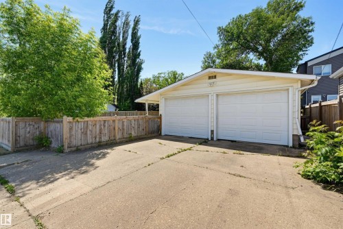 Detached two-car garage with white paneled doors and light-colored siding - 11619 122 Street, Edmonton, AB 