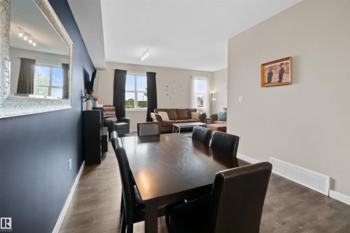 Open-concept living space featuring wood-finish flooring - 13 2803 James Mowatt Trail, Edmonton, AB 
