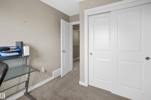 Interior room featuring neutral wall paint, light brown carpeting, and white baseboards - 13 2803 James Mowatt Trail, Edmonton, AB 