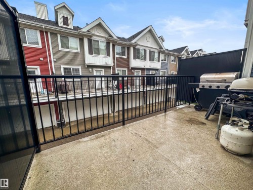 Spacious balcony with concrete flooring and dark metal railings - 13 2803 James Mowatt Trail, Edmonton, AB 