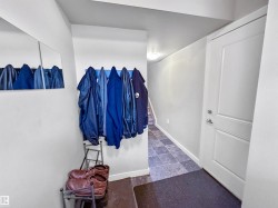 Entryway featuring a white paneled door with brushed nickel hardware, recessed ceiling lighting, and a tiled flooring surface - 