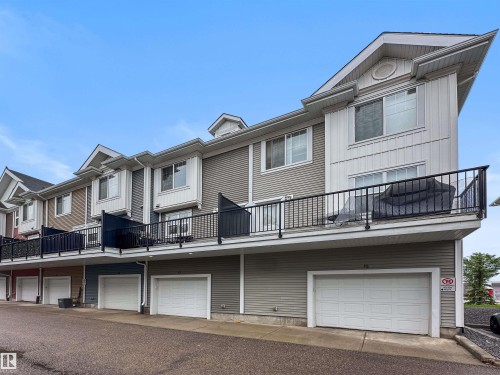 Multi-level townhome exterior featuring contemporary siding in varied tones - 13 2803 James Mowatt Trail, Edmonton, AB 