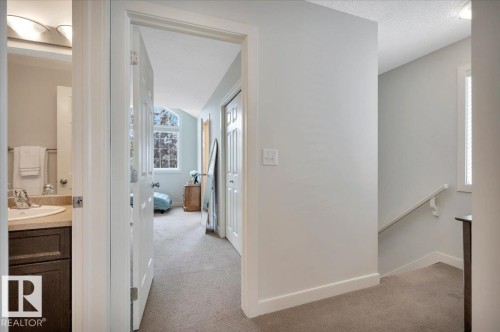 Carpeted hallway with staircase leading to the three bedrooms - 4865 Terwillegar Common, Edmonton, AB - Indoor Photo Showing Other Room