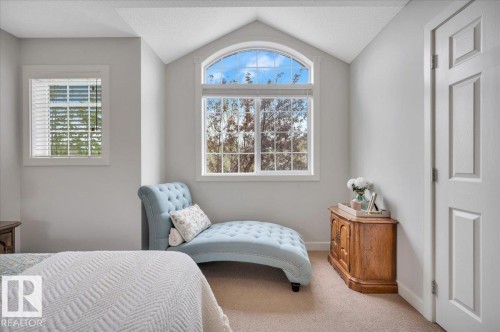 Room featuring a vaulted ceiling and an arched-top window - 4865 Terwillegar Common, Edmonton, AB - Indoor Photo Showing Bedroom