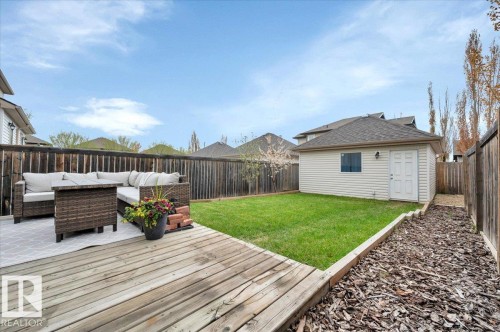 Private fenced backyard featuring a wood deck and detached double garage - 4865 Terwillegar Common, Edmonton, AB - Outdoor With Deck Patio Veranda With Exterior