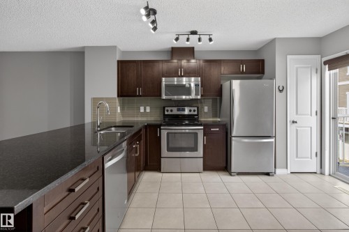 11 1140 Chappelle Boulevard, Edmonton, AB - Indoor Photo Showing Kitchen With Stainless Steel Kitchen With Double Sink With Upgraded Kitchen
