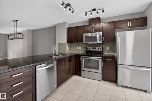 11 1140 Chappelle Boulevard, Edmonton, AB - Indoor Photo Showing Kitchen With Stainless Steel Kitchen With Double Sink With Upgraded Kitchen