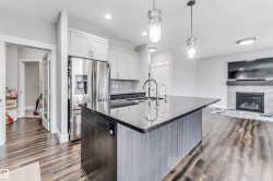 Open-concept living space with wood-finish flooring - 