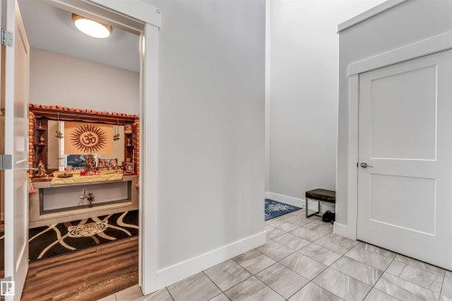 Entryway featuring light-toned tile flooring and a two-panel interior door - 8516 216 Street, Edmonton, AB 