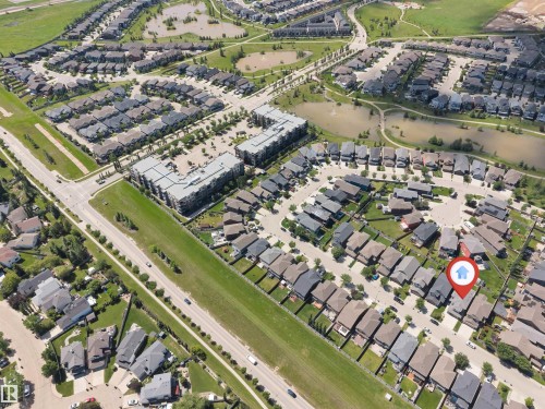 Aerial view showcasing a residential community with single-family homes and multi-story apartment buildings - 8516 216 Street, Edmonton, AB 