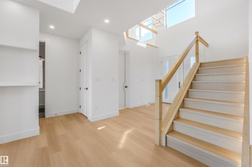 Hardwood flooring throughout the entry, staircase, and interior spaces - 1180 Genesis Lake Boulevard, Stony Plain, AB 