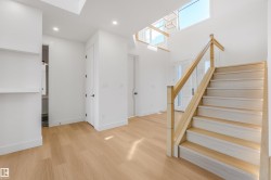 Hardwood flooring throughout the entry, staircase, and interior spaces - 