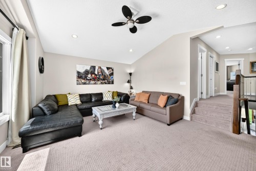 Spacious living area featuring vaulted ceilings, recessed lighting, and a ceiling fan - 13724 166 Avenue Nw, Edmonton, AB 