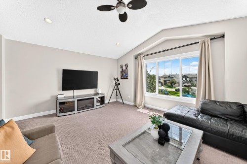 Living room featuring a large picture window, recessed lighting, ceiling fan, and carpeted flooring - 13724 166 Avenue Nw, Edmonton, AB 