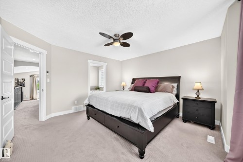 Carpeted bedroom with a ceiling fan, light-toned walls, and white trim - 13724 166 Avenue Nw, Edmonton, AB 