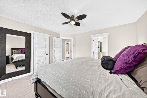 Spacious room featuring neutral carpeting, light-toned wall paint, and white trim - 13724 166 Avenue Nw, Edmonton, AB 