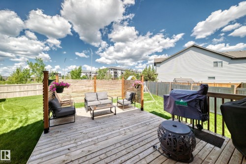 Expansive backyard featuring a large wood-finish deck with a wooden privacy screen - 13724 166 Avenue Nw, Edmonton, AB 