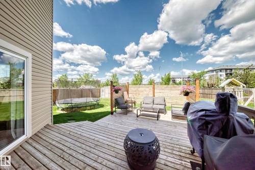 Rear wood deck featuring a built-in privacy wall, offering ample space for outdoor seating and recreation - 13724 166 Avenue Nw, Edmonton, AB 