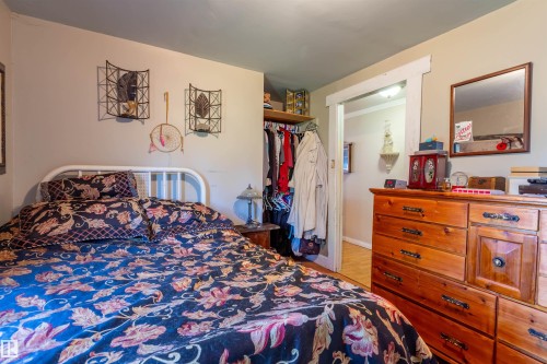 Bedroom featuring light-toned walls, a contrasting blue ceiling, and a doorway with white trim - 551027 Range Road 193, Rural Lamont County, AB 