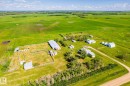 Expansive agricultural property featuring multiple outbuildings, fenced enclosures, a primary residence, and a long driveway - 551027 Range Road 193, Rural Lamont County, AB 