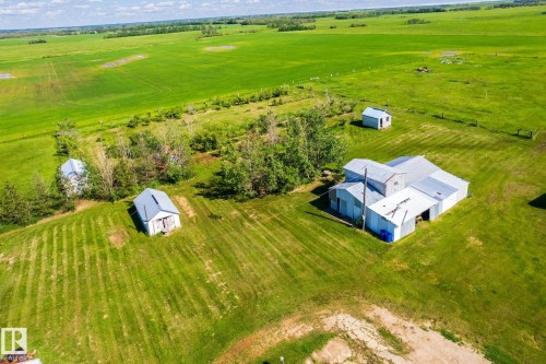 Expansive green acreage featuring a multi-building property with multiple outbuildings and a primary structure with a metal roof - 551027 Range Road 193, Rural Lamont County, AB 