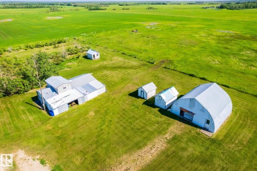 Expansive green acreage featuring multiple outbuildings, including a large Quonset-style structure - 551027 Range Road 193, Rural Lamont County, AB 