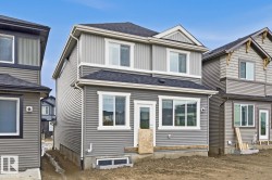 Two-story residential structure featuring gray horizontal siding and light gray vertical siding accents - 