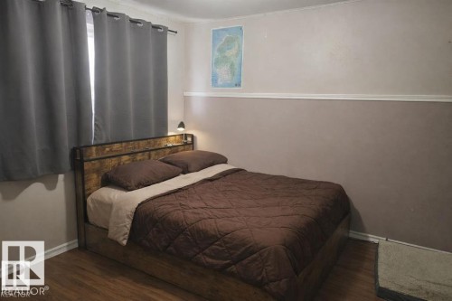 Room featuring wood-finish flooring and two-tone painted walls with chair rail molding - 13204 131A Avenue Nw, Edmonton, AB - Indoor Photo Showing Bedroom