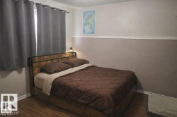 Room featuring wood-finish flooring and two-tone painted walls with chair rail molding - 