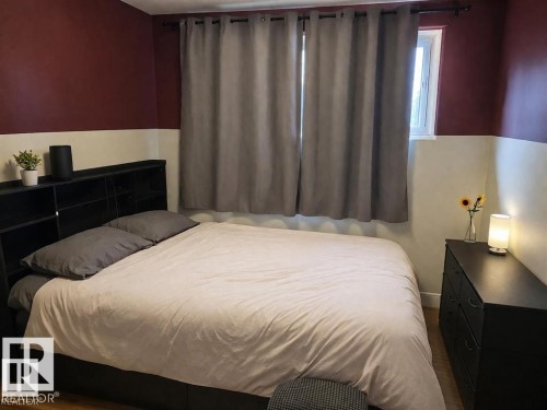 Room featuring a two-tone wall with a deep red upper section and a light lower section - 13204 131A Avenue Nw, Edmonton, AB - Indoor Photo Showing Bedroom