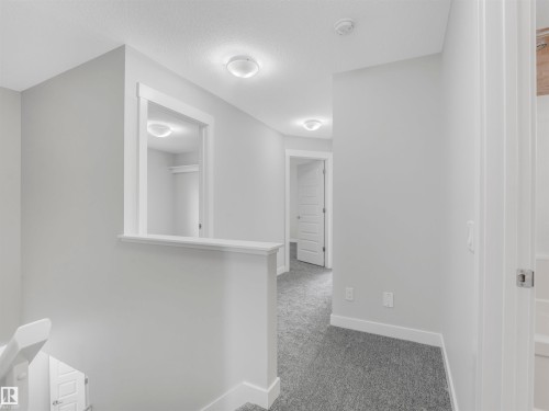 Hallway featuring light gray walls, white trim, recessed lighting, and gray carpet flooring - 20507 99 Avenue, Edmonton, AB - Indoor Photo Showing Other Room