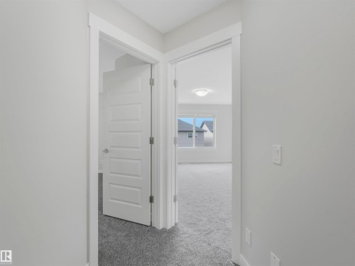 Interior hallway featuring light gray walls, white trim, and gray carpet - 20507 99 Avenue, Edmonton, AB - Indoor Photo Showing Other Room
