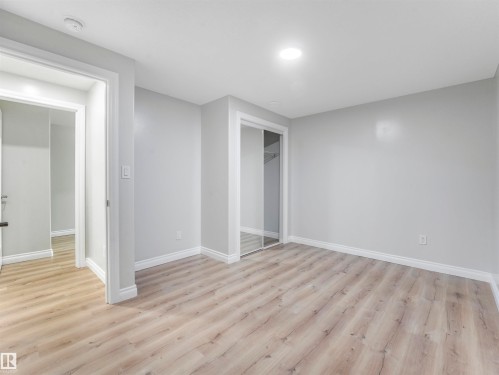 Neutral paint palette with wood-finish flooring - 20507 99 Avenue, Edmonton, AB - Indoor Photo Showing Other Room