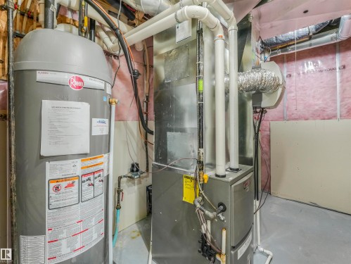 Mechanical room featuring a water heater, furnace, and exposed insulation - 20507 99 Avenue, Edmonton, AB - Indoor Photo Showing Basement