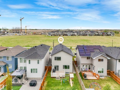 Rear exterior with a wood deck, a fenced yard, and a visible construction area - 20507 99 Avenue, Edmonton, AB - Outdoor