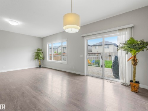 Spacious interior featuring wood-finish flooring, light grey wall paint, and recessed lighting - 20507 99 Avenue, Edmonton, AB - Indoor Photo Showing Other Room