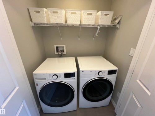 Dedicated laundry area featuring a white wire shelving unit, providing elevated storage capacity - 8 Meadowlink Common, Spruce Grove, AB - Indoor Photo Showing Laundry Room