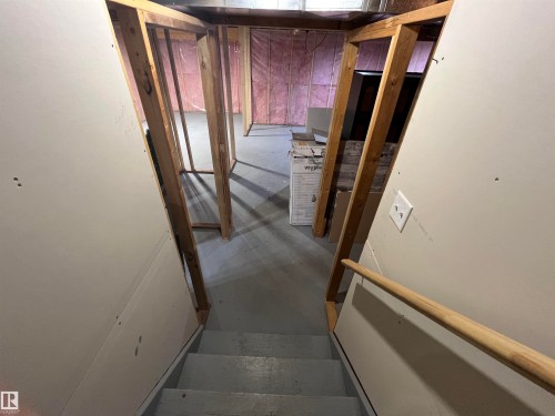 Partially finished basement with framed wall sections, exposed insulation, and a painted concrete floor - 8 Meadowlink Common, Spruce Grove, AB - Indoor Photo Showing Other Room