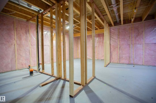 Unfinished lower level featuring wooden framing, exposed ceiling joists, and insulated perimeter walls - 8 Meadowlink Common, Spruce Grove, AB - Indoor Photo Showing Other Room
