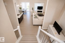 Open-concept living space with light-toned wood-finish flooring - 