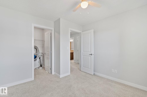 Neutral-toned room featuring a ceiling fan with integrated lighting, light gray walls, and light-colored carpet flooring - 614 Mcdonough Link, Edmonton, AB 